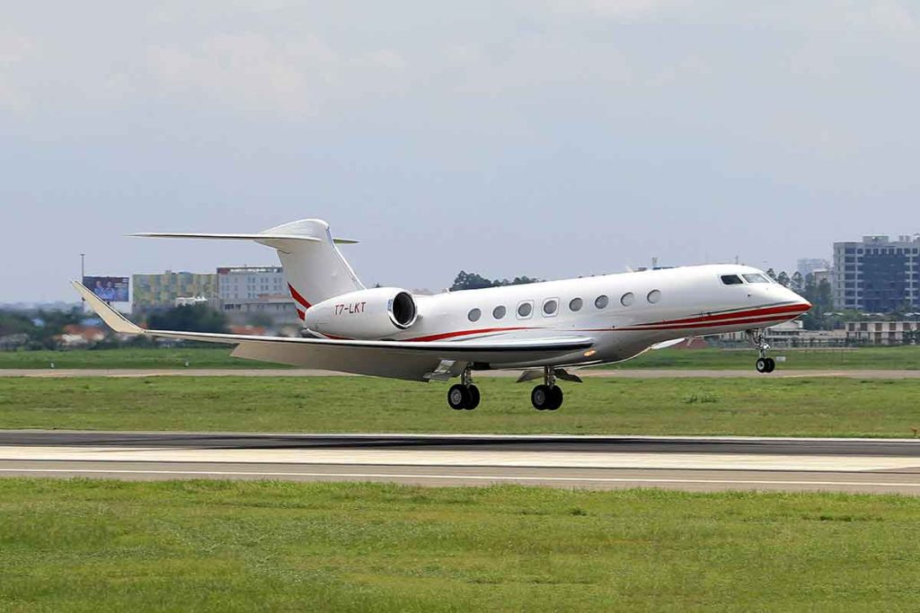 Jet rental aircraft parked on airport runway, ready for departure
